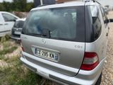 a silver car that is parked on the side of the road