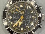 a close up of a watch with a black face