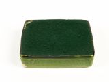 a small green box sitting on a white surface
