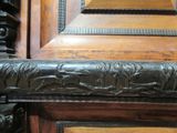 a close up of a wooden door with carvings on it