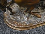a bronze statue of a horse and rider on a base