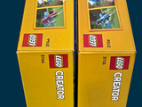two boxes of legos that are sitting on a table