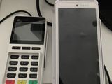 a cellphone and a cell phone sitting next to each other on a table