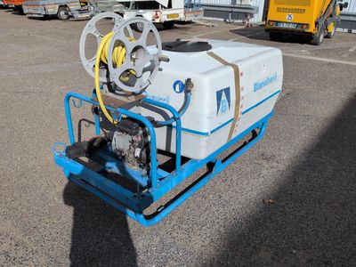 a white tank sitting on a blue cart in a parking lot