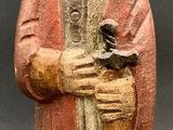 figurine of a man with a beard holding a bird