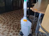 a vacuum that is sitting on the floor in the room