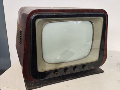 a small television sitting on a table with a white wall in the background