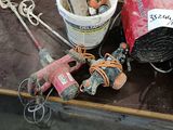 a table with tools and a bucket of paint on it