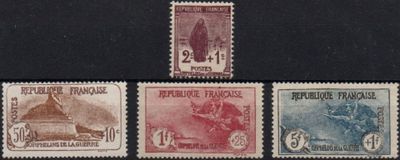 four different stamps of different colors on a black surface