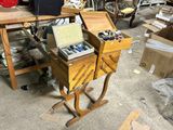 a wooden table with two drawers and a box on it