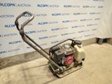 an image of a small lawn mower in a garage