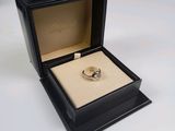 l'image d'une bague dans un cadre noir posé sur une surface blanche