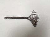 a metal spoon with a handle on a white surface