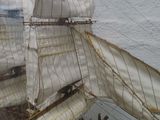 a model of a sailboat on display in a glass case
