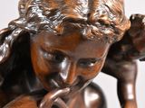 bronze statue of a woman holding a child in her arms