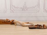two pairs of women ' s shoes are sitting on a wooden floor