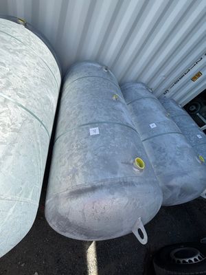 two large tanks sitting next to each other on the side of a building