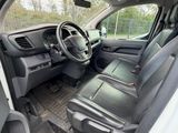 the interior of a white van with black leather seats and a steering wheel
