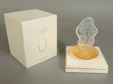 a perfume bottle that is sitting on top of a box