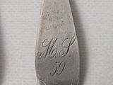 two spoons that have been engraved with the names of two people
