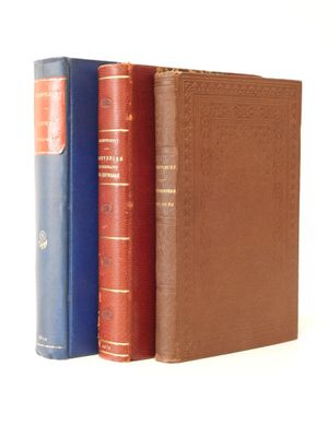 three books are stacked on top of each other on a white surface