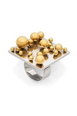 a close up of a ring with gold spheres on it