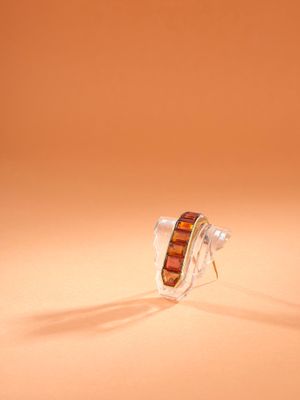 a close up of a pair of earrings sitting on top of a table