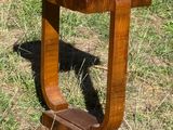 a small wooden table that is sitting in the grass
