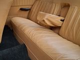 a tan leather couch in the back of a car