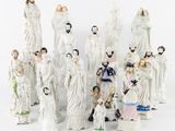 a lot of figurines of people that are standing together