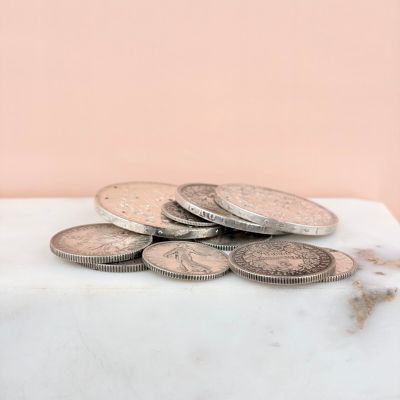 a pile of coins sitting on top of a marble counter