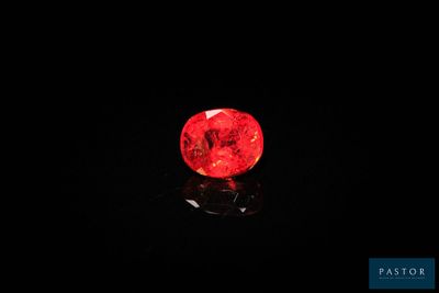 un diamant rouge sur une surface noire