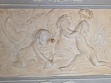 a relief of two cherensils on the wall of a building
