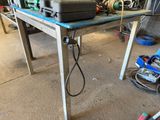 a laptop computer sitting on a table in a garage