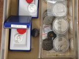 a box full of coins and other items on a table