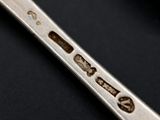 close up of a spoon with a metal handle on a black surface