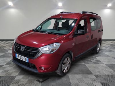 the red van is parked on a checkered floor in the garage