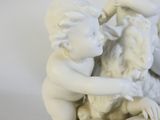 a statue of a boy and a girl holding a sheep