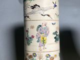 a white vase with a design of birds and flowers on it