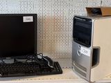 a desktop computer sitting on a shelf next to a monitor and keyboard