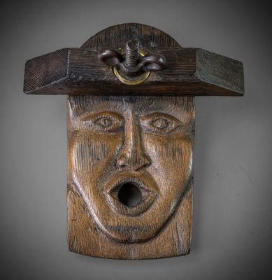 a wooden sculpture of a man with a hat on his head