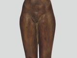 statue of a woman holding a book on a wooden base