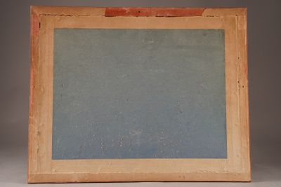 an old picture frame sitting on top of a table next to a white wall
