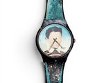 a close up of a watch with a picture of a man on it