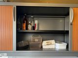a metal cabinet with a bunch of items in it