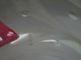 a close up of a red handle on a silver pot