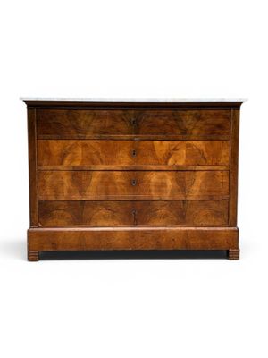 an antique chest of drawers with marble top