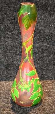 a vase that has a green and red design on it