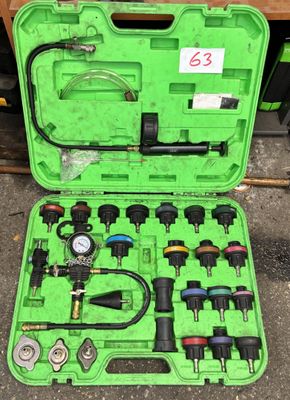 an image of a green case filled with tools on top of a table