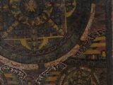 painting of a circular design on a wooden surface with a black background